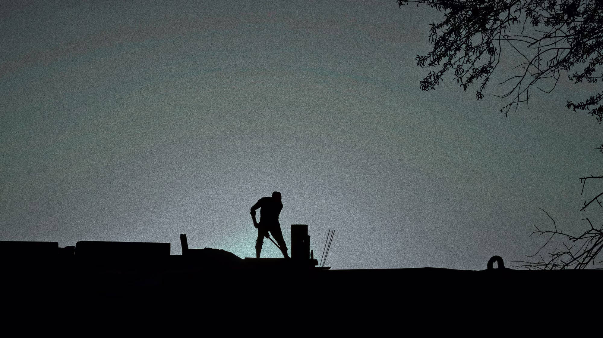 A Terraform crew member working a ridgeline at dusk